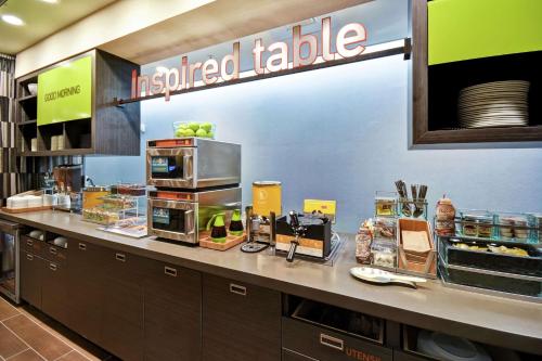 a fast food restaurant with a counter with food at Home2 Suites By Hilton Smyrna Nashville in Smyrna