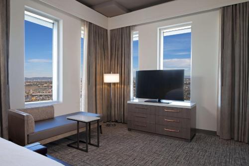 a hotel room with a bed and a flat screen tv at H Hotel Los Angeles, Curio Collection By Hilton in Los Angeles