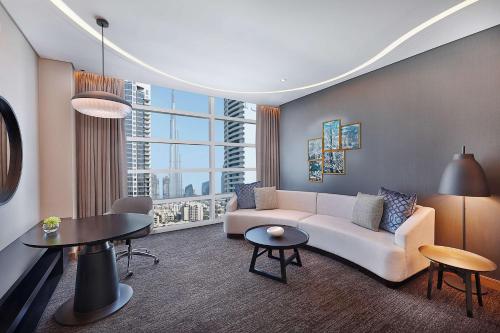 a living room with a couch and a table at DoubleTree by Hilton Dubai - Business Bay in Dubai