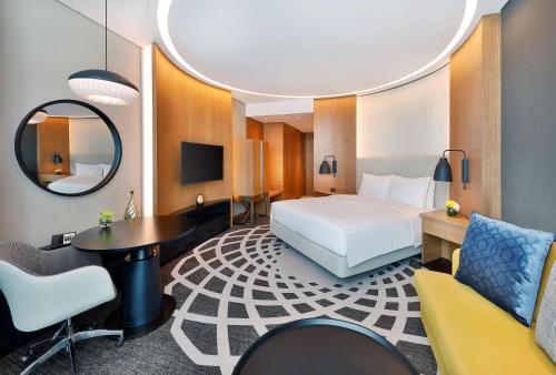 a hotel room with a bed and a desk at DoubleTree by Hilton Dubai - Business Bay in Dubai
