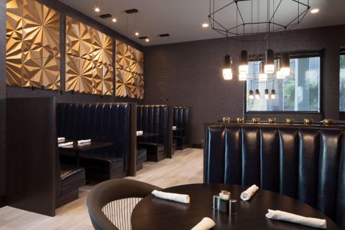 a dining room with a table and chairs at H Hotel Los Angeles, Curio Collection By Hilton in Los Angeles