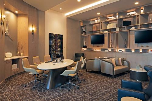 a waiting room with a table and chairs at H Hotel Los Angeles, Curio Collection By Hilton in Los Angeles