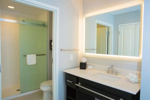 a bathroom with a sink and a toilet and a mirror at Homewood Suites By Hilton Allentown Bethlehem Center Valley in Center Valley