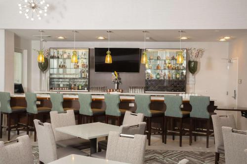 a bar in a restaurant with chairs and a counter at Homewood Suites By Hilton Allentown Bethlehem Center Valley in Center Valley