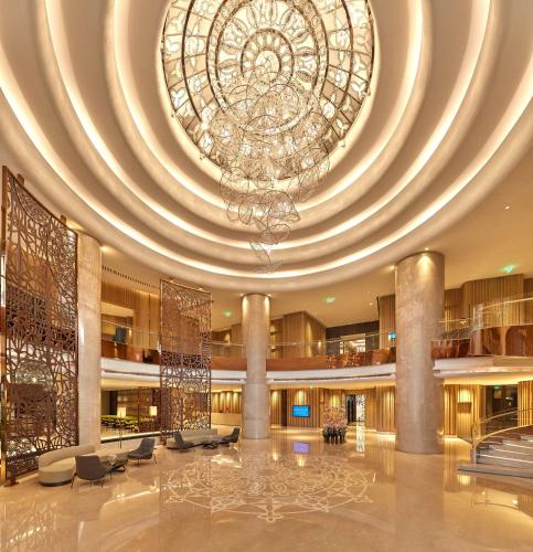 a large lobby with a large chandelier in a building at Conrad Bengaluru in Bengaluru