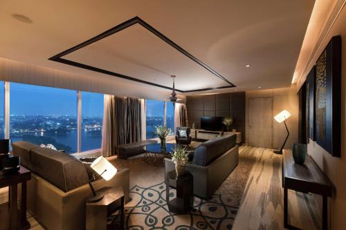 a living room with a view of a city at Conrad Bengaluru in Bengaluru