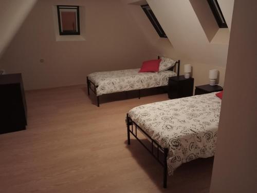 a room with two beds and two night stands at Les orangers in Oloron-Sainte-Marie