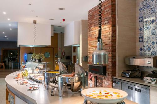 a kitchen with a counter with some food on it at Hilton Cabo Verde Sal Resort in Santa Maria