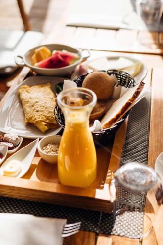 a tray of breakfast food on a wooden table at Hilton Cabo Verde Sal Resort in Santa Maria