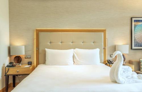 a bedroom with a bed with a swan on it at Hilton Cabo Verde Sal Resort in Santa Maria
