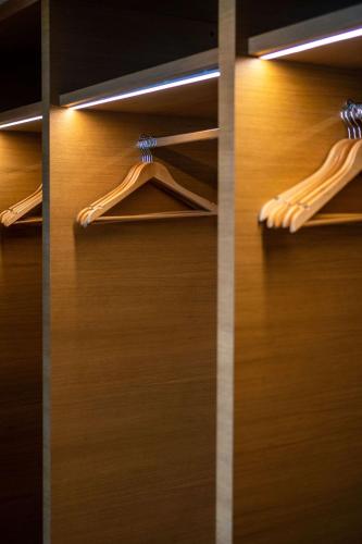 a closet with wooden doors with hangers at Hilton Cabo Verde Sal Resort in Santa Maria