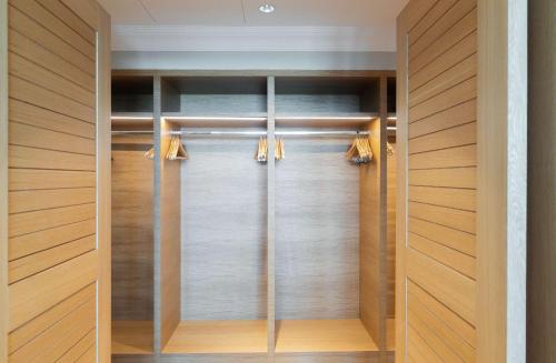 a walk in closet with wood paneling and glass doors at Hilton Cabo Verde Sal Resort in Santa Maria