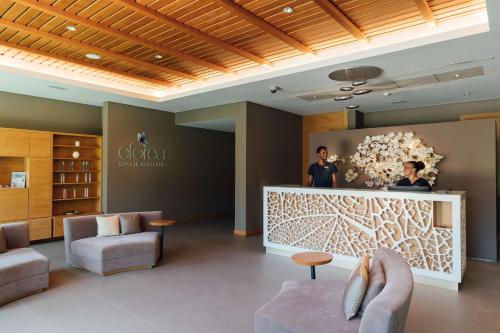 a lobby with two people standing behind a counter at Hilton Cabo Verde Sal Resort in Santa Maria