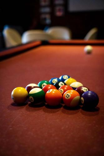 a group of billiard balls on a pool table at Hilton Cabo Verde Sal Resort in Santa Maria