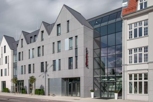 an office building with a glass facade at Hampton By Hilton Gdansk Oliwa in Gdańsk