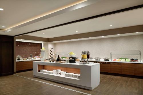 a kitchen with a counter with food on it at Hilton Washington DC National Mall The Wharf in Washington