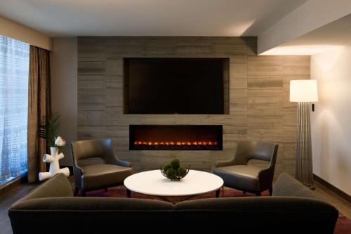 a living room with a couch and a fireplace at Hilton Washington DC National Mall The Wharf in Washington