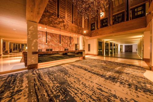 a large hallway with a large rug in a building at Doubletree By Hilton Weerawila Rajawarna Resort in Weerawila
