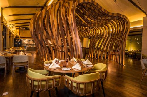 a dining room with a table and chairs at DoubleTree by Hilton Weerawila Rajawarna Resort in Weerawila