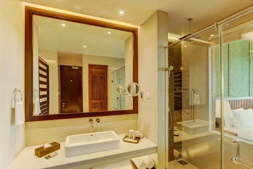 a bathroom with a sink and a shower at DoubleTree by Hilton Weerawila Rajawarna Resort in Weerawila