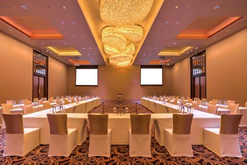 a conference room with white tables and chairs at DoubleTree by Hilton Weerawila Rajawarna Resort in Weerawila