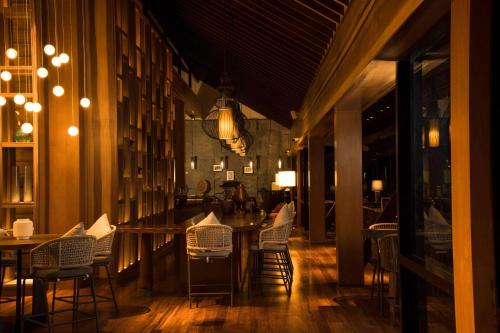 a dining room with chairs and a table and a table and chairsktop at DoubleTree by Hilton Weerawila Rajawarna Resort in Weerawila