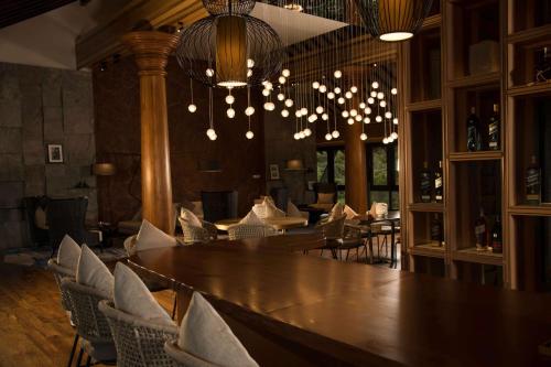 a dining room with a large wooden table and chairs at DoubleTree by Hilton Weerawila Rajawarna Resort in Weerawila