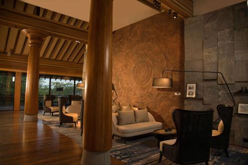a living room with a couch and chairs at DoubleTree by Hilton Weerawila Rajawarna Resort in Weerawila