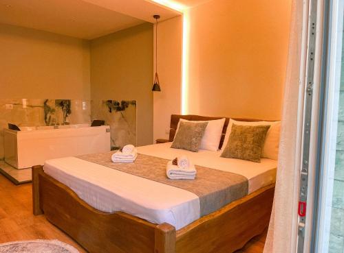 a bedroom with a bed with two towels on it at Vila Alpini in Razëm