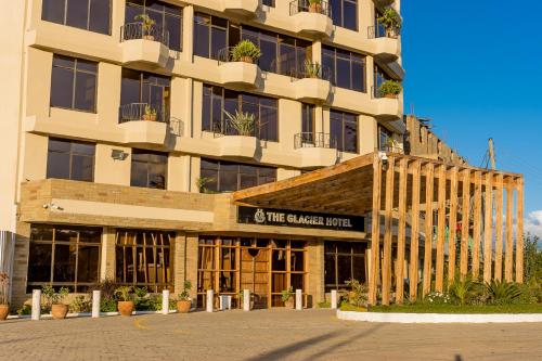 a building with a sign that reads the palace hotel at The Glacier Hotel Nanyuki in Nanyuki