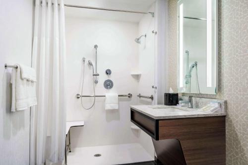 a white bathroom with a sink and a shower at Hilton Garden Inn Annapolis Downtown in Annapolis