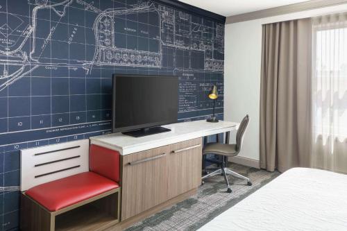 a room with a desk with a monitor and a chair at Hilton Garden Inn Annapolis Downtown in Annapolis