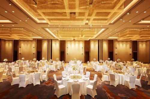 a banquet hall with white tables and chairs at Hilton Suzhou in Suzhou