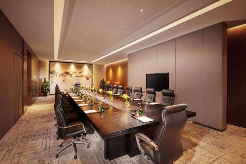 a large conference room with a long table and chairs at Hilton Suzhou in Suzhou