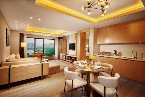 a kitchen and living room with a table and a couch at Hilton Suzhou in Suzhou