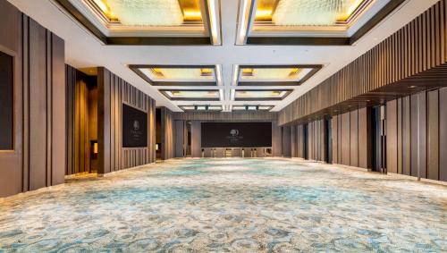 a large hallway with a large room with a stage at DoubleTree by Hilton Surabaya in Surabaya