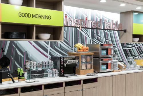 a fast food restaurant with a counter with food at Home2 Suites By Hilton Orlando Airport in Orlando