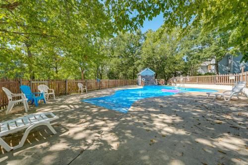 a swimming pool with a bench and a gazebo at 3 Mi to Silver Dollar City! Family Getaway with Pool in Branson