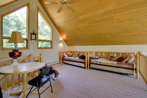 a room with two beds and a table and chairs at Lakefront Brainerd Cabin with Fireplace! in Brainerd
