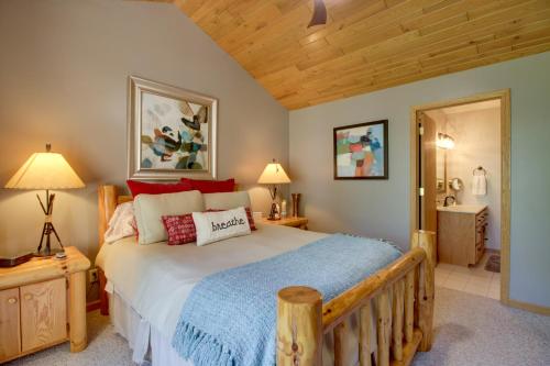 a bedroom with a large bed and a wooden ceiling at Lakefront Brainerd Cabin with Fireplace! in Brainerd