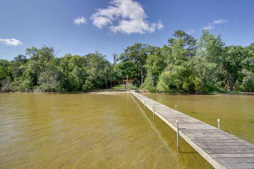 a dock in the middle of a body of water at Lakefront Brainerd Cabin with Fireplace! in Brainerd