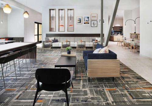 a lobby with a couch and chairs and tables at Homewood Suites By Hilton San Diego Central in San Diego