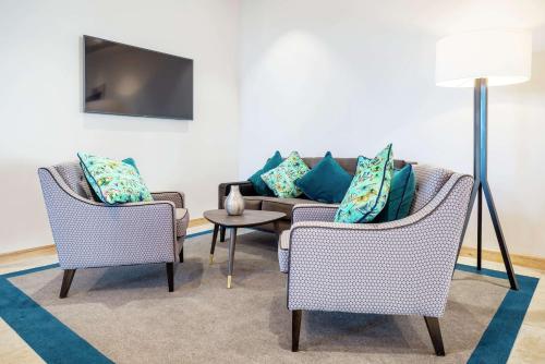 a living room with two chairs and a couch at Hampton By Hilton Stockton On Tees in Stockton-on-Tees