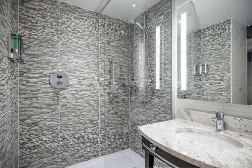 a bathroom with a shower and a sink at Hampton By Hilton Stockton On Tees in Stockton-on-Tees