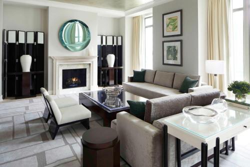 a living room with a couch and a fireplace at Waldorf Astoria Atlanta Buckhead in Atlanta