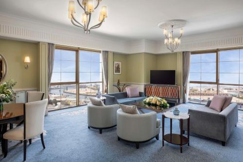 a living room with a couch and a table at Habtoor Palace Dubai, LXR Hotels & Resorts in Dubai