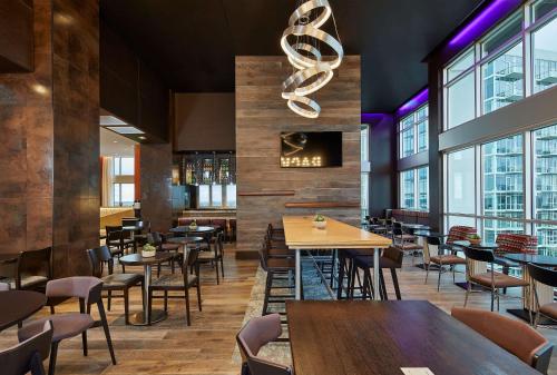 a restaurant with tables and chairs and windows at Hampton Inn & Suites Atlanta-Midtown, Ga in Atlanta