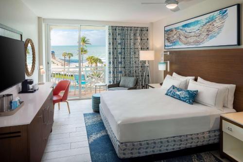 a hotel room with a bed and a view of the ocean at The Reach Key West, Curio Collection by Hilton in Key West