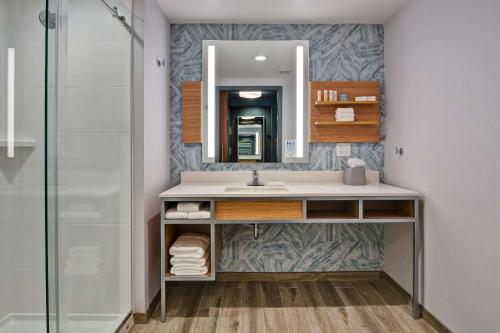 a bathroom with a sink and a mirror at Hilton Garden Inn Destin Miramar Beach, Fl in Destin