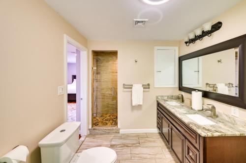 a bathroom with a toilet and a sink and a mirror at Waltham Vacation Rental about 12 Mi to Downtown Boston in Waltham